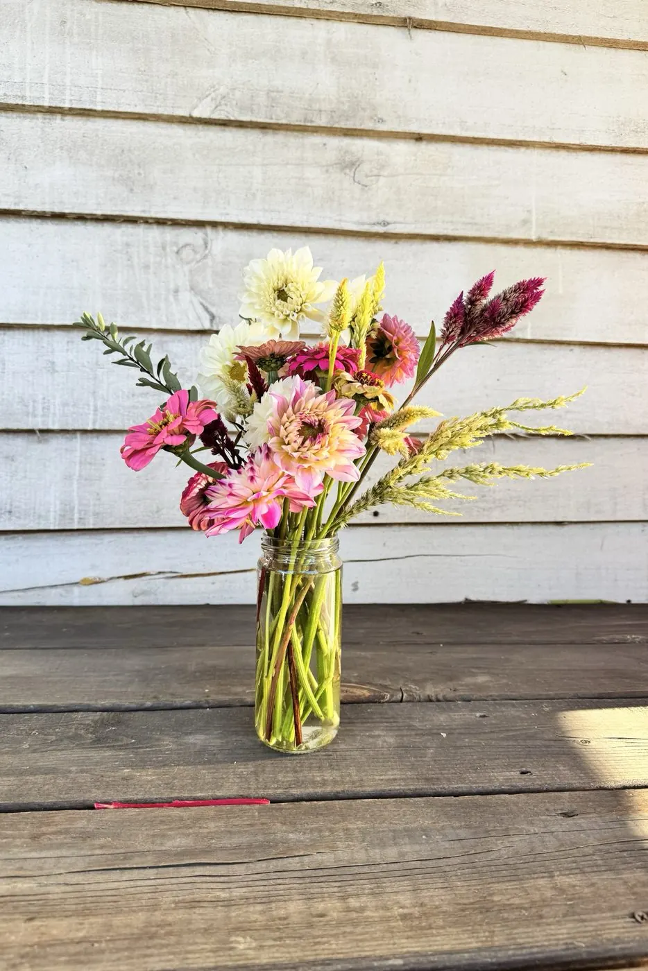 Jar bouquet of dahlias, zinnias, and celosia from Little Afton Flowers