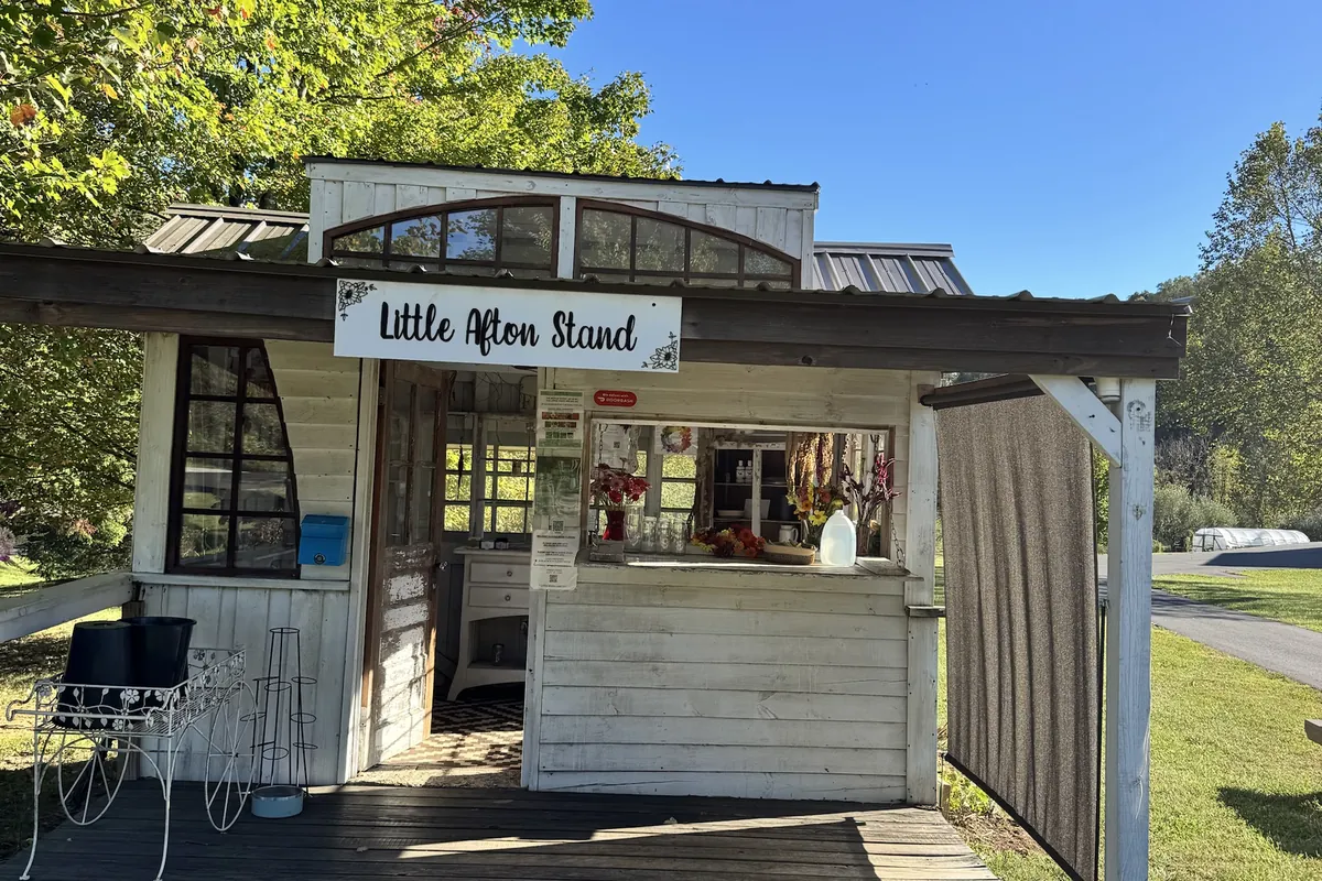 The Little Afton Stand flower house, open under the maple tree on Dick Woods Road