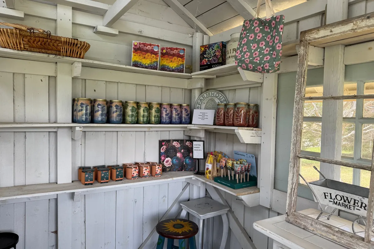 Shelves of candles, seed packets, puzzles and flower totes inside the shop